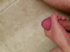 Asian guy masturbates and cums on the floor