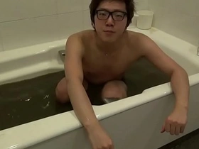 Young Japanese gay man enjoys bathing with powder